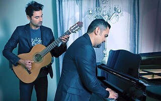 Musicians performing live at the Banana Festival with piano and guitar on stage.
